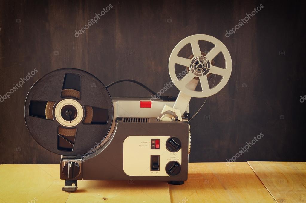 Old 8mm Film Projector over wooden table and textured background — Stock  Photo © tomert #76577163