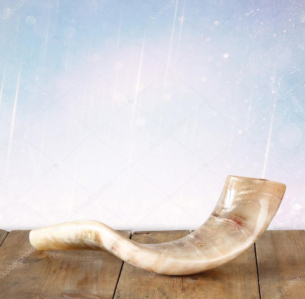 Shofar (horn) on wooden table. rosh hashanah (jewish holiday) concept . traditional holiday