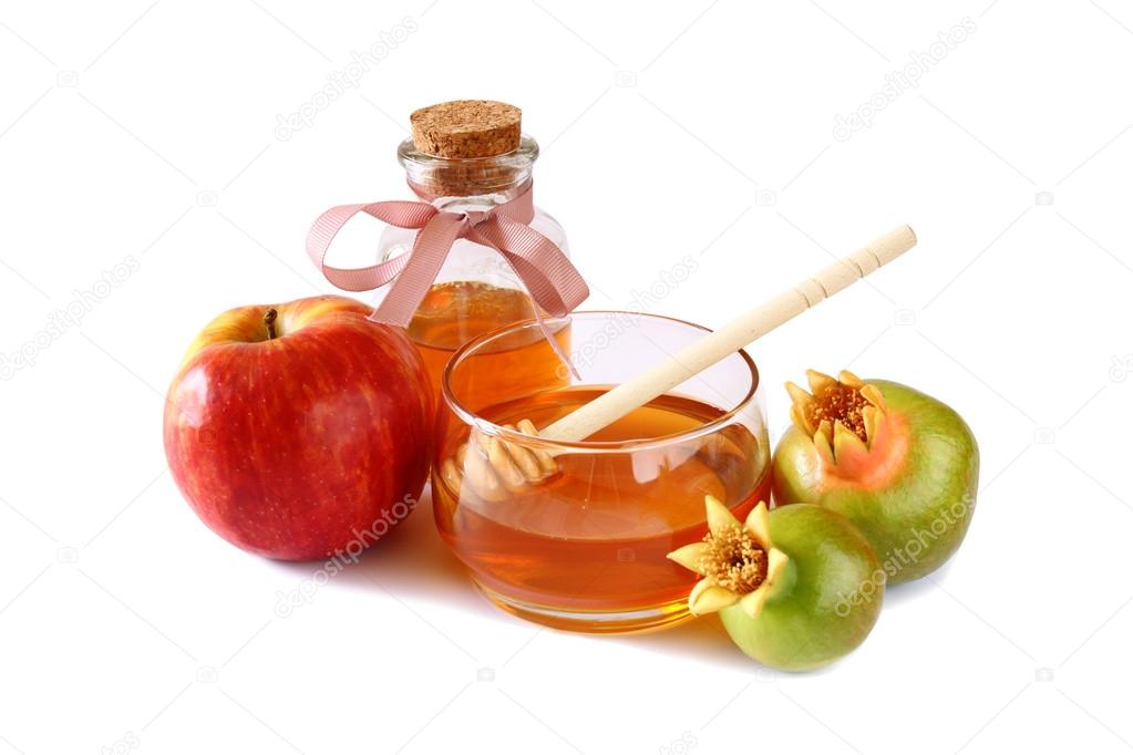 rosh hashanah (jewesh holiday) concept - honey, apple and pomegranate isolated on white. traditional holiday symbols.