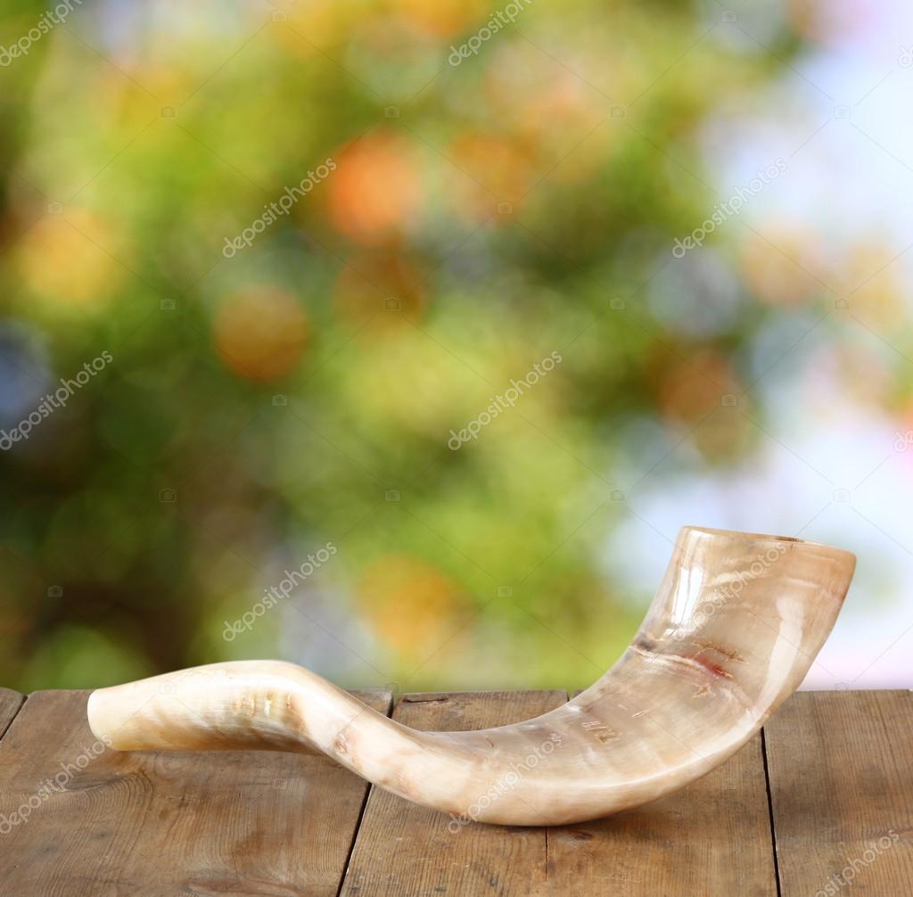 Shofar (horn) on wooden table. rosh hashanah (jewish holiday) concept