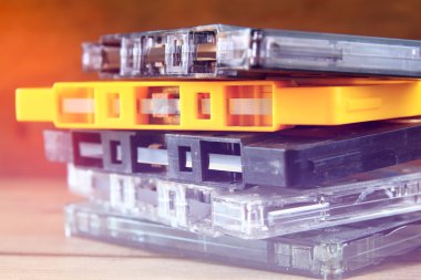 close up photo of stack of Cassette tapes over wooden table . retro style image