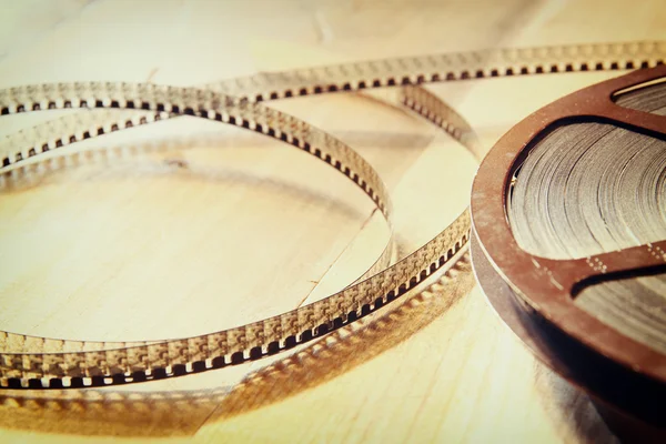 Top view image of old 8 mm movie reel over wooden background — Stock Photo, Image