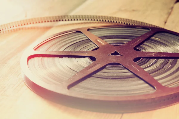 top view image of old 8 mm movie reel over wooden background