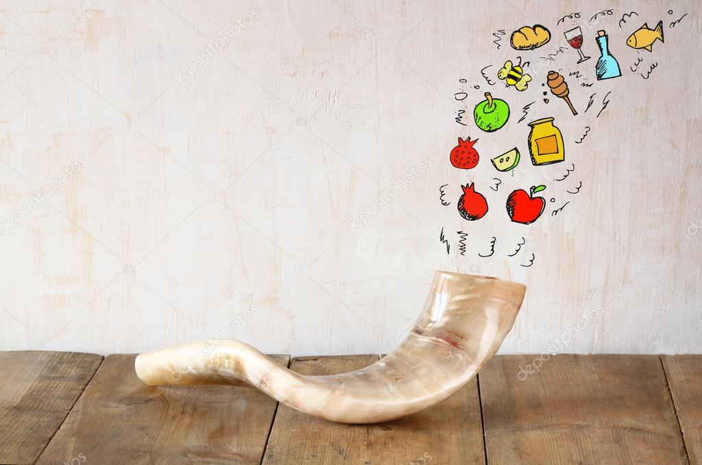 shofar (horn) on wooden table with set of infographics over textured background. rosh hashanah (jewish holiday) concept . traditional holiday symbol.