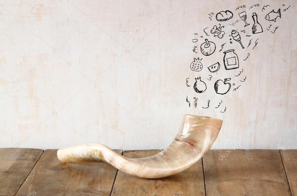 shofar (horn) on wooden table with set of infographics over textured background. rosh hashanah (jewish holiday) concept . traditional holiday symbol.