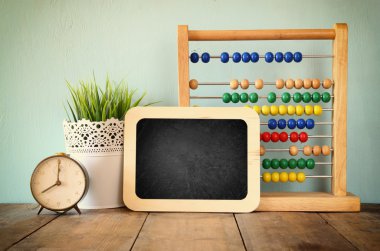 Blackboard, colorful abacus and clock