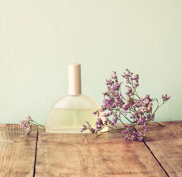 Perfume bottle with flowers Stock Photo by ©tomert 80293412