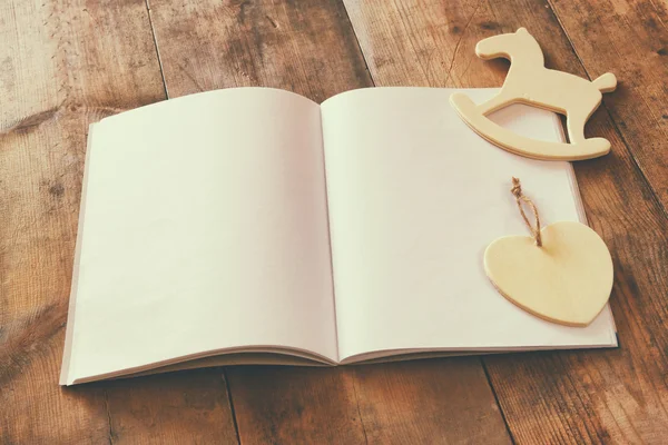 Notebook and wooden horse toy — Stock Photo, Image