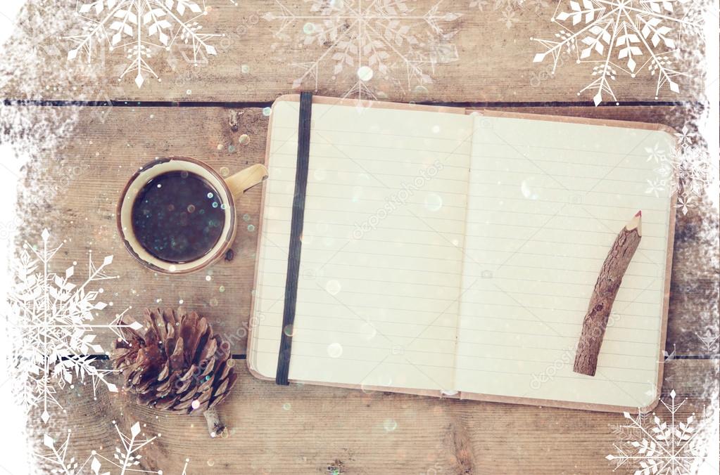 top image of open notebook with blank pages, next to pine cones and cup of coffee over wooden table. top image, glitter overly with snowflakes.