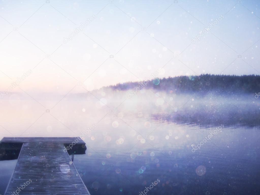 abstract photo of misty and foggy lake at morning sunrise