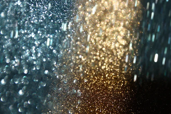 Glitter vintage osvětlení pozadí. Zlatá, modrá a černá. rozostření. — Stock fotografie