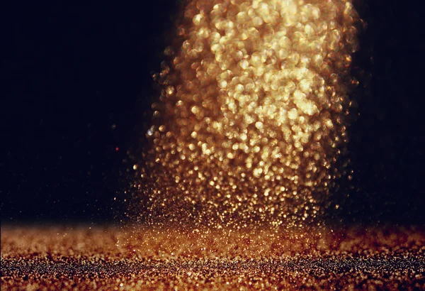 Glitter vintage ljus bakgrund. guld och svart. defocused. — Stockfoto