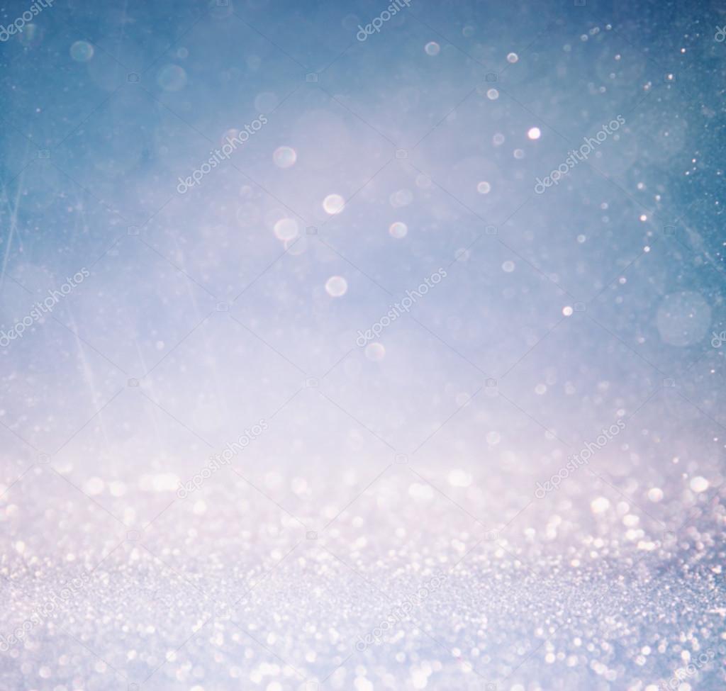 bokeh lights background with multi layers and colors of white silver and blue.