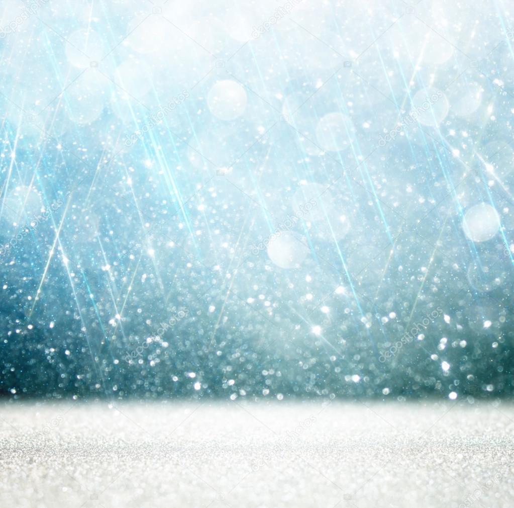 bokeh lights background with multi layers and colors of white silver and blue.