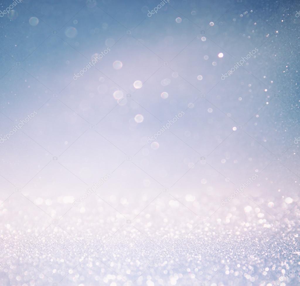 bokeh lights background with multi layers and colors of white silver and blue.