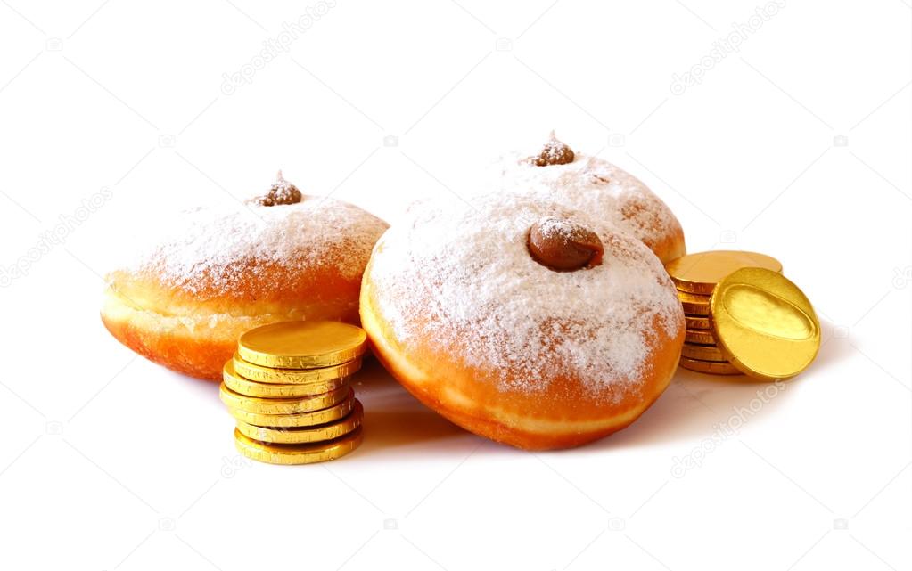 image of jewish holiday Hanukkah with donuts, traditional chocolate coins and wooden dreidels (spinning top). isolated on white.