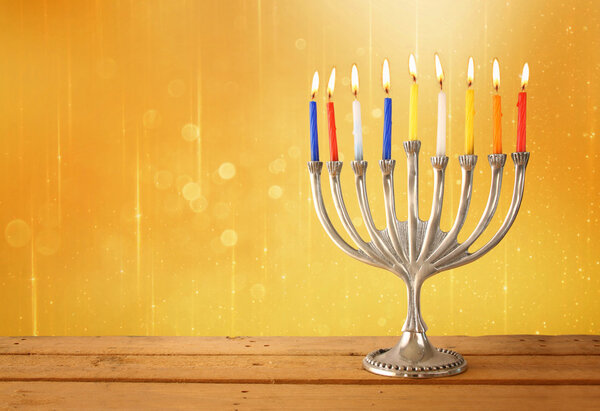 Image of jewish holiday Hanukkah background with menorah (traditional candelabra) and Burning candles.