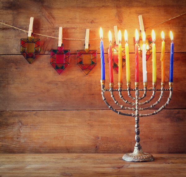 Image of jewish holiday Hanukkah background with menorah (traditional candelabra) and Burning candles.