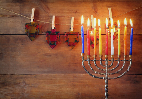 Image of jewish holiday Hanukkah background with menorah (traditional candelabra) and Burning candles.