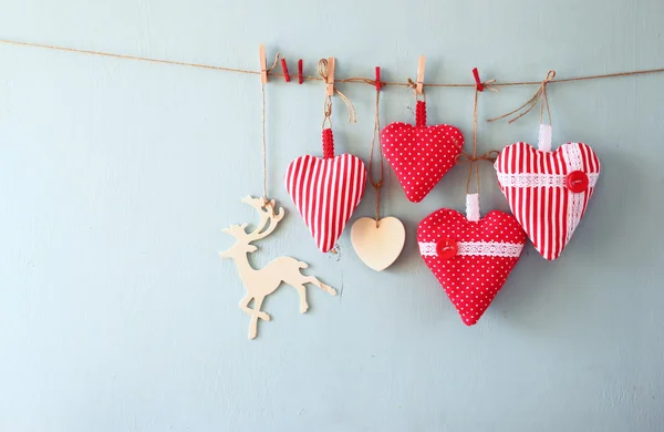 Fabric red hearts and wooden reindeer — Stock fotografie
