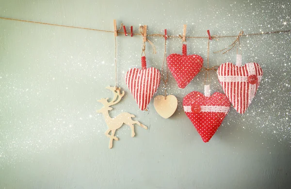 Fabric red hearts and wooden reindeer — Stockfoto