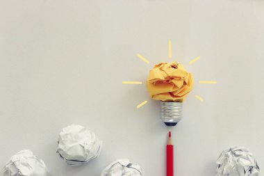Eğitim konsepti imajı. Yaratıcı fikir ve yenilik. Buruşmuş kağıt ampul metaforu olarak