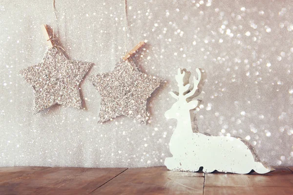 Wooden reindeer and glitter stars — Stock Photo, Image