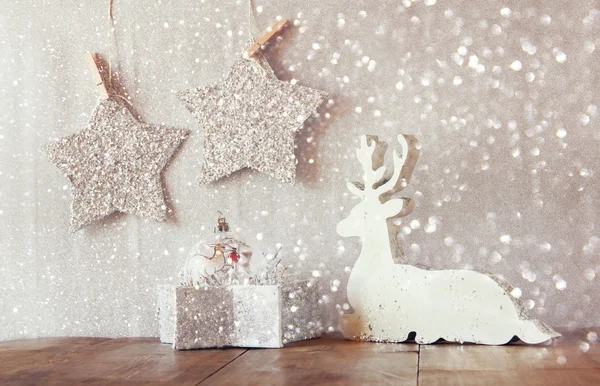Wooden reindeer and glitter stars — Stock Photo, Image