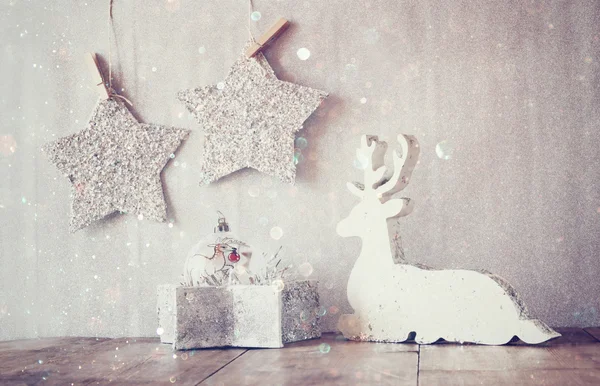 Wooden reindeer and glitter stars — Stock Photo, Image