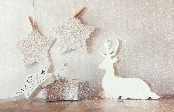 Wooden reindeer and glitter stars — Stock Photo, Image