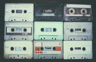 close up photo of cassette tape over wooden table . top view. retro filtered. clipart