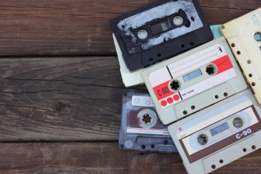 close up photo of cassette tape over wooden table . top view. retro filtered.