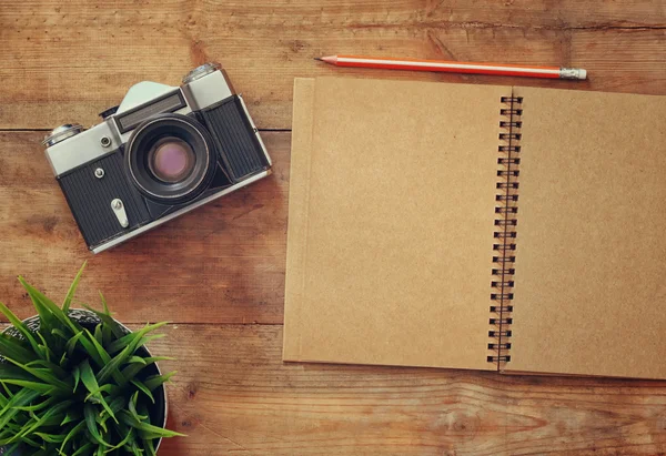 Top view image of blank notebook and old camera. — Stockfoto