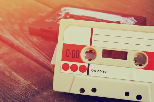 Close up photo of cassette tape over wooden table . top view. retro filtered. — Zdjęcie stockowe