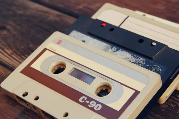 Close up photo of cassette tape over wooden table . top view. retro filtered. — Zdjęcie stockowe