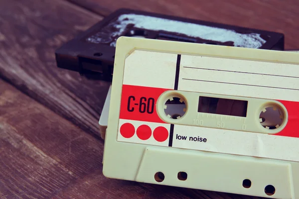 Close up photo of cassette tape over wooden table . top view. retro filtered. — Stock Photo, Image