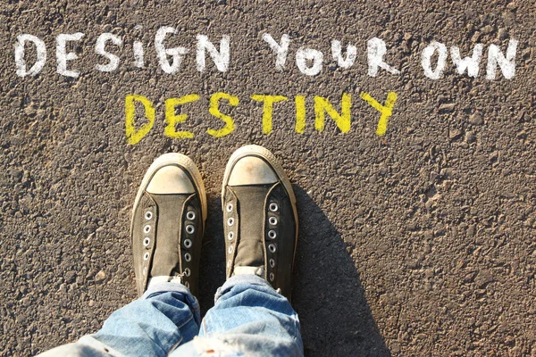 Top view image of person in jeans and sneakers with the text - design your own destiny. — Stock Fotó