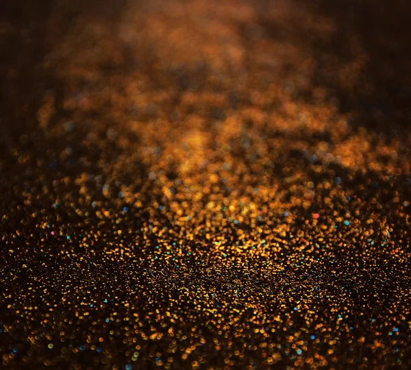 Glitter vintage lights background. dark gold and black. defocused. — Stock Photo, Image