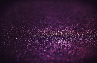 abstract glitter purple lights background.
