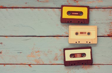 close up photo of vintage cassette tape over aqua wooden table . top view. retro filtered. clipart