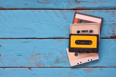 close up photo of vintage cassette tape over aqua wooden table . top view. retro filtered. clipart