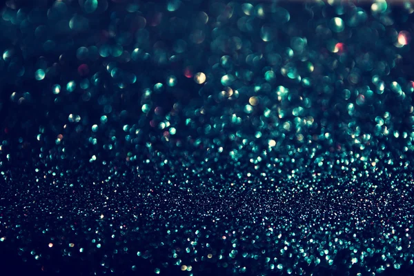 Glitter vintage lights background. gold, green, blue and black. de-focused — Stock Photo, Image