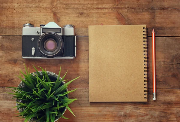 Top view image of blank notebook and old camera. — Stockfoto