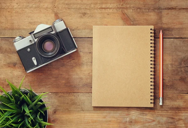 Imagem vista superior de notebook em branco e câmera antiga . — Fotografia de Stock