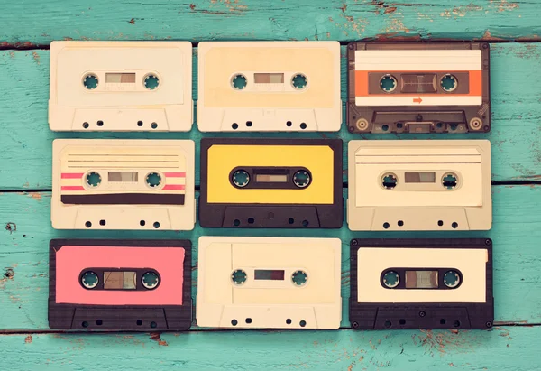 Close up photo of vintage cassette tape over aqua wooden table . top view. retro filtered. — Stock Photo, Image