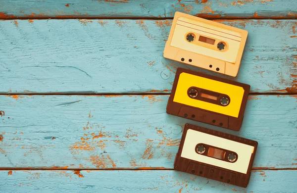 Close up photo of vintage cassette tape over aqua wooden table . top view. retro filtered. — Stock Photo, Image