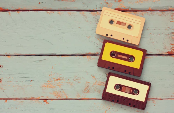 Close up photo of vintage cassette tape over aqua wooden table . top view. retro filtered — Stock Photo, Image