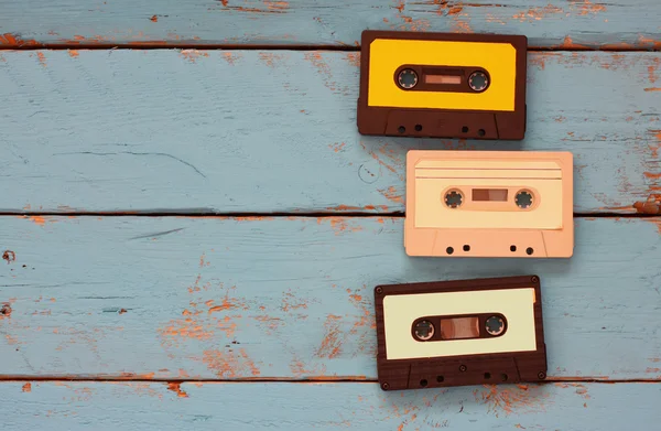 Close up photo of vintage cassette tape over aqua wooden table . top view. retro filtered — Stock Photo, Image