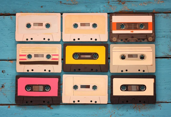 Close up photo of vintage cassette tape over aqua wooden table . top view. retro filtered — Stock Photo, Image