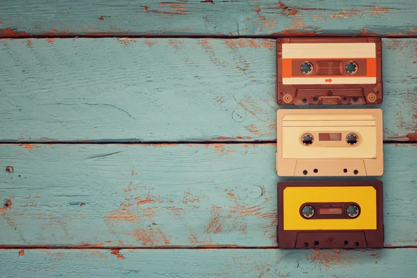 Close up photo of vintage cassette tape over aqua wooden table . top view. retro filtered — Stock Photo, Image